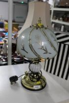 A table lamp with glass shade