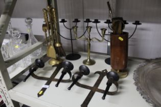 A collection of candle holders and fire irons