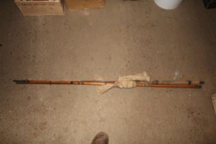 A vintage cane three piece fishing rod with carry