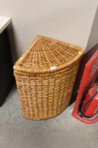 A wicker corner linen basket