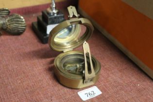 A reproduction brass compass (78)