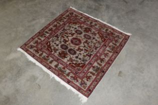 An approx. 3'6" x 3'6" patterned rug