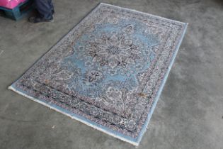 An approx. 5'9" x 4' blue patterned rug AF