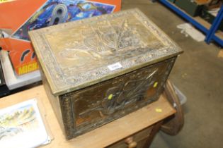 A brass embossed coal box decorated with ships