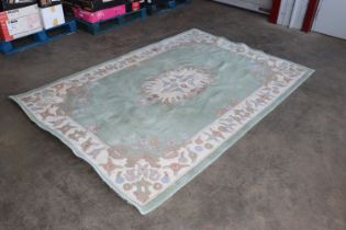 An approx. 9' x 6' green floral patterned rug AF