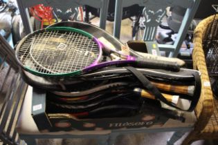 A box containing various tennis rackets etc