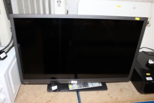 A Toshiba flat screen television with remote contr