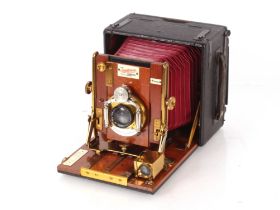 A wooden and brass mounted Unicum bellow camera by