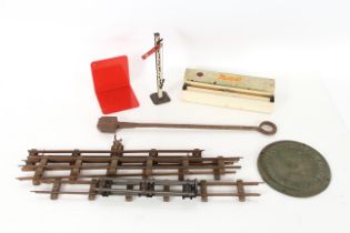 A tin plate signal; various "O" gauge track; a Lis