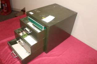 A metal three drawer filing chest and contents of