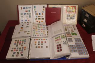 A box of world stamps in albums, mostly sorted by