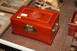 A Chinese hardwood trinket box with brass handles