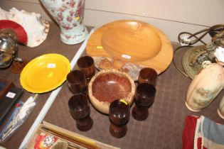 A turned wooden bowl and goblets; and another simi