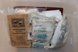 A box containing various stamps and First Day cove