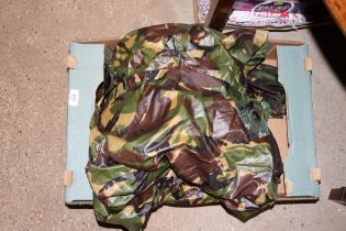 A box of various camouflage clothing