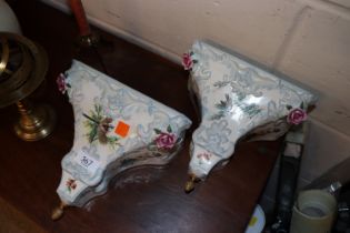 A pair of porcelain floral decorated wall brackets