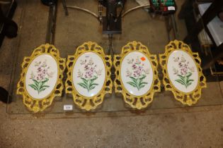 A set of four porcelain floral wall plates