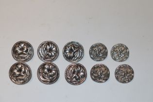 A set of six silver buttons decorated with flowers