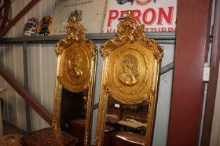 A pair of decorative gilt framed bevel edged wall