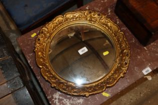 A gilt framed circular convex wall mirror