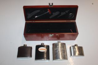 A wine box containing hip flasks, wine thermometer