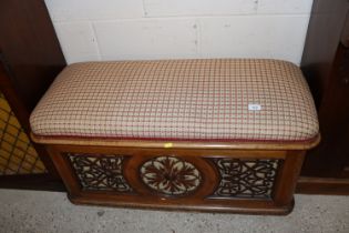 A Victorian walnut fret carved window seat with up
