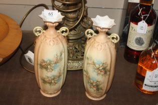 A pair of floral decorated vases