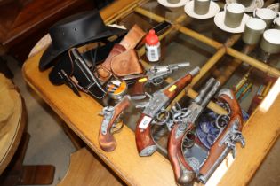 A leather hat; various replica guns, air gun pelle