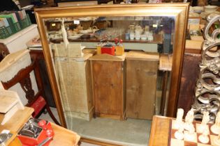 A large gilt framed bevel edged wall mirror