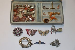 A jewellery box and contents to include brooches,