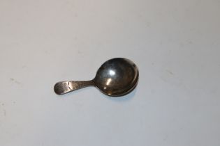 A Georgian silver caddy spoon with engraved Fleur