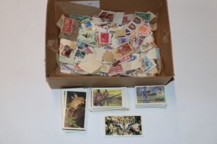 A box containing various loose stamps and cigarett