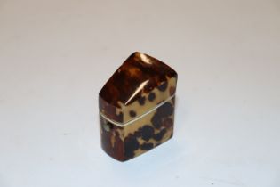 A tortoiseshell clad thimble holder