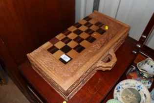 A carved chess board and backgammon set