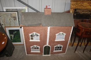 A large dolls house and three boxes of doll's hous