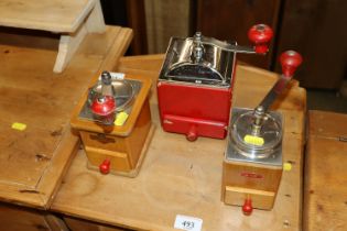 Three vintage coffee grinders to include Kym