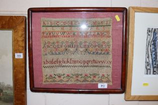 A Victorian sampler in mahogany frame