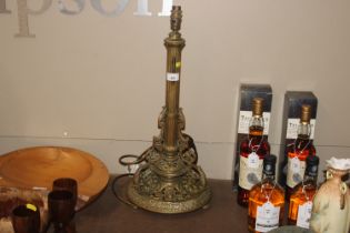 A brass Corinthian column table lamp with ornate p