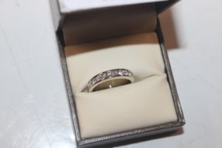 An 18ct white gold (marks rubbed); a half eternity