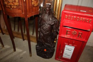 An carved hardwood Oriental figure