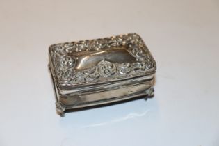 A silver rectangular small jewellery box having em