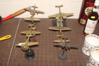 Eight period brass cast models of WWII era planes raised on stands and plinths
