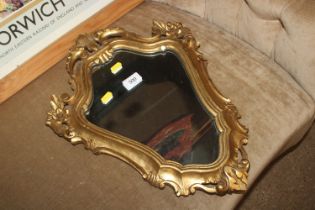 A gilt framed decorative wall mirror