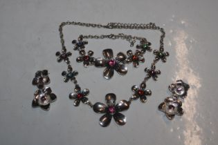 A white metal and coloured stone set necklace with