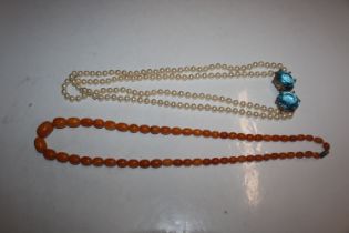 An amber coloured bead necklace and a simulated pe