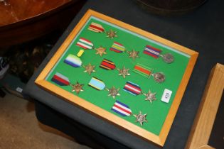 A frame of WWII medals, some WWII issue with some