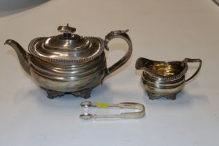 A silver teapot with matching cream jug, and a pai