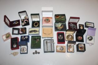 A box containing micro mosaic brooches and various