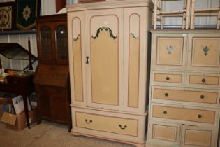 A painted and decorated single door wardrobe fitte