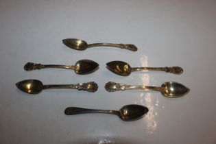 Five Continental white metal gilt spoons and a sil